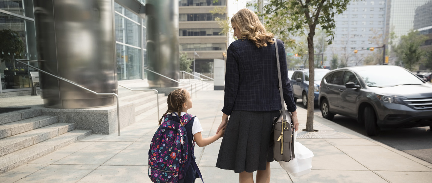 working mother and daughter on their way home